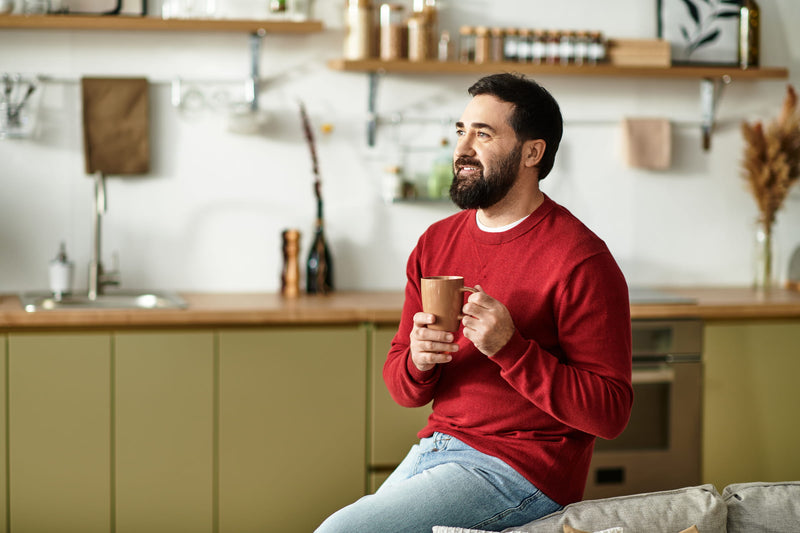Confident man at home enjoying his morning — representative of adults evaluating eligibility for ZuvoMed's clinician-supervised men's sexual health program.